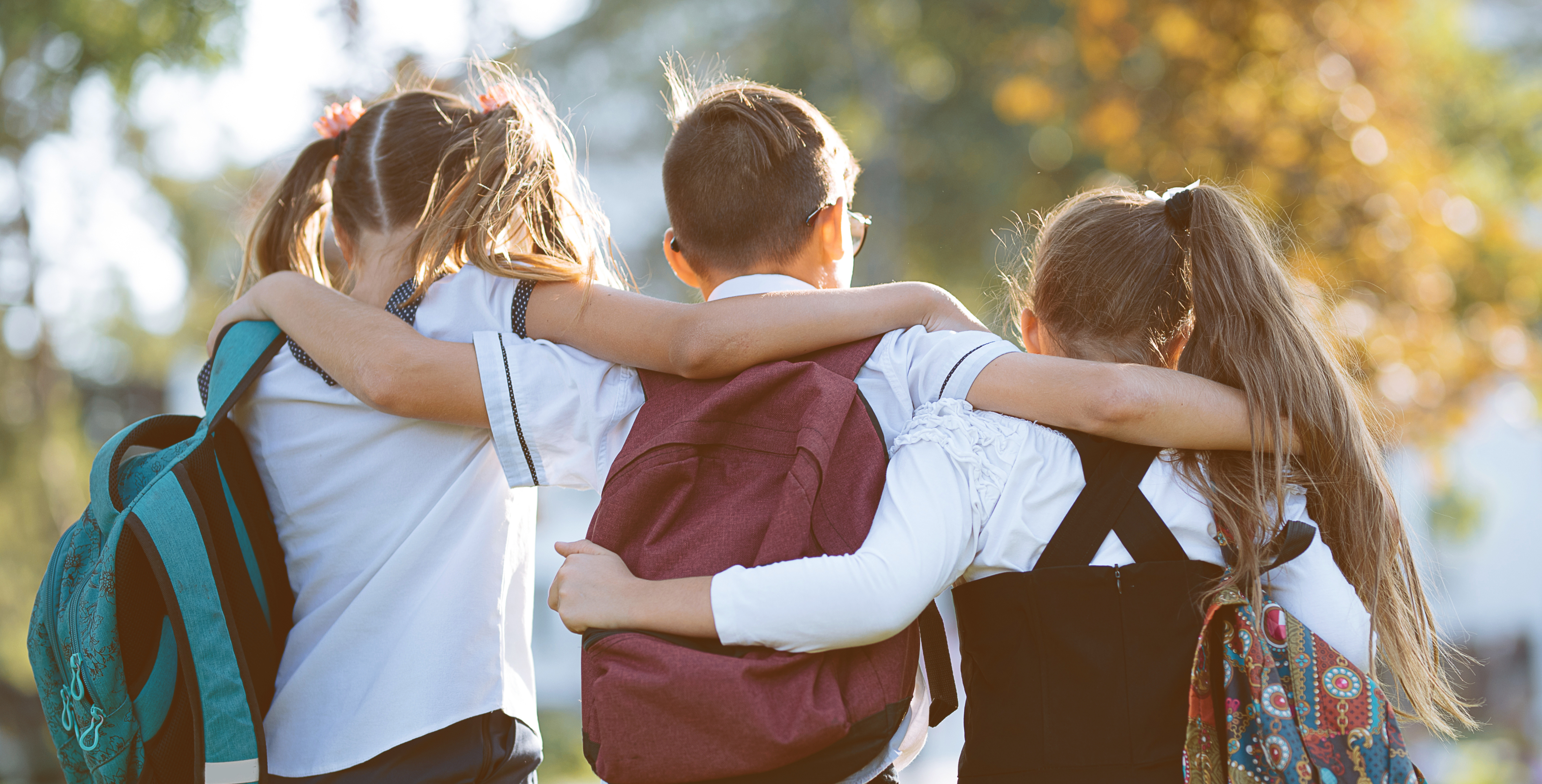 Children walking to school with backpacks.